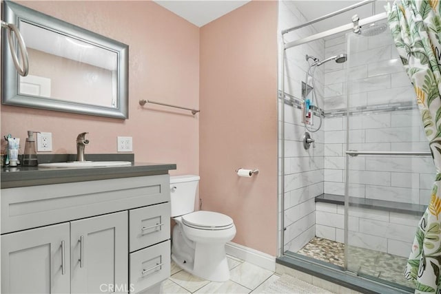 bathroom featuring toilet, a shower stall, vanity, and baseboards