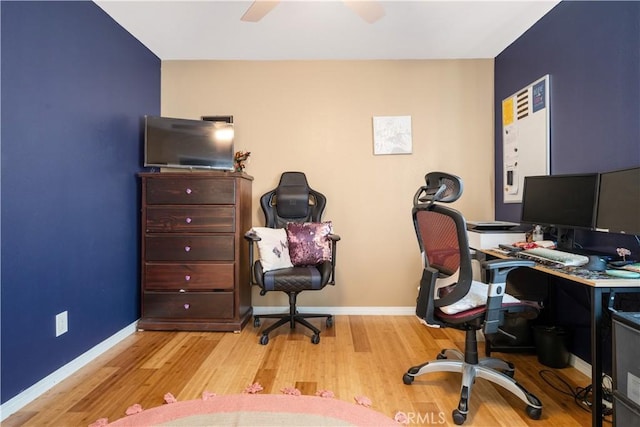 office space with a ceiling fan, wood finished floors, and baseboards