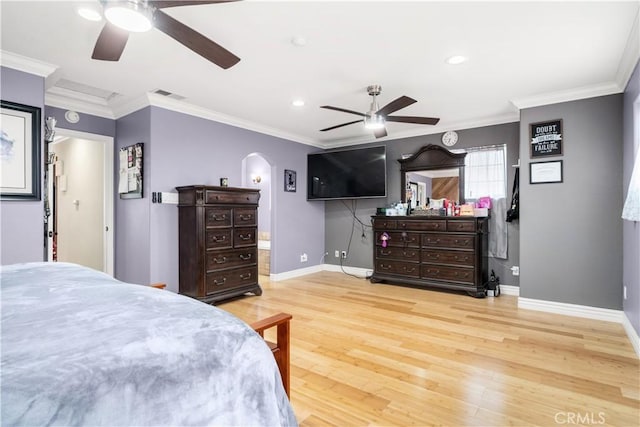 bedroom featuring ornamental molding, wood finished floors, visible vents, and baseboards