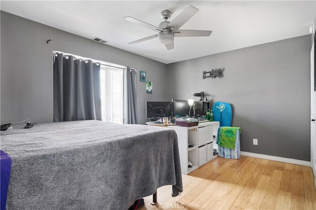 bedroom featuring visible vents, ceiling fan, baseboards, and light wood-style floors