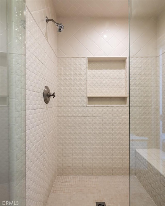 bathroom with a tile shower
