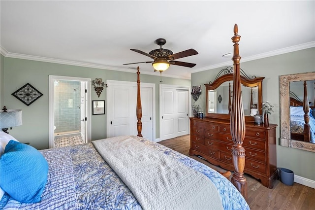 bedroom featuring crown molding, ceiling fan, baseboards, wood finished floors, and ensuite bathroom