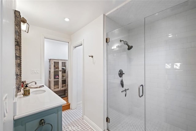 full bathroom featuring recessed lighting, baseboards, a shower stall, and vanity