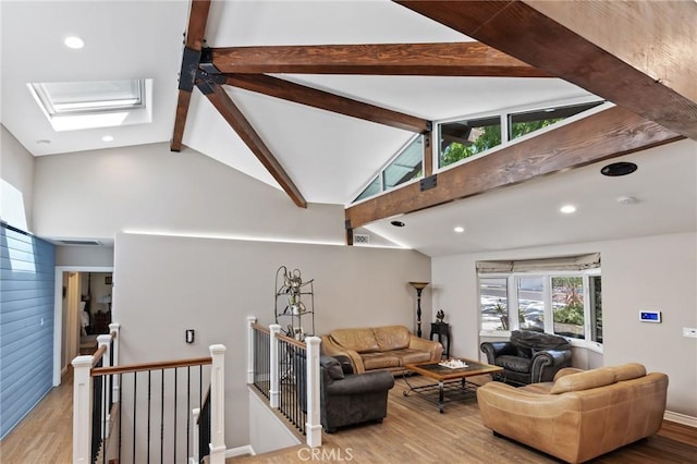 living room with wood finished floors, recessed lighting, beam ceiling, and a skylight