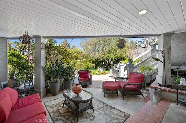 view of patio with fence, an outdoor hangout area, and area for grilling