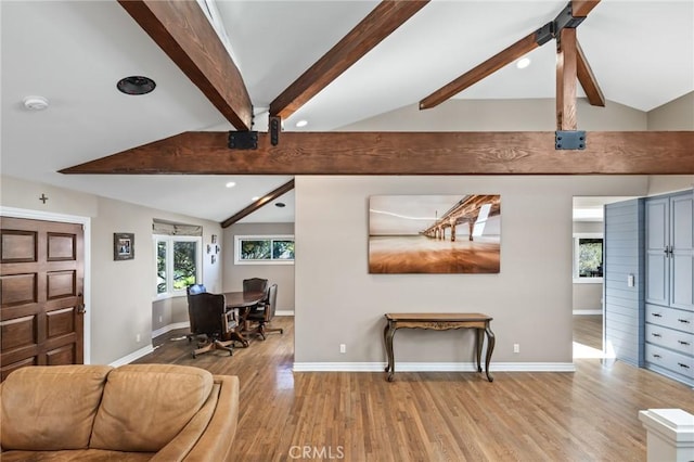 living area featuring recessed lighting, baseboards, lofted ceiling with beams, and wood finished floors