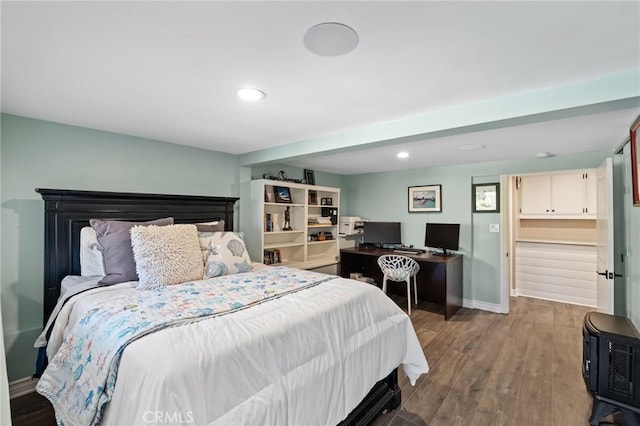 bedroom featuring baseboards, recessed lighting, and wood finished floors