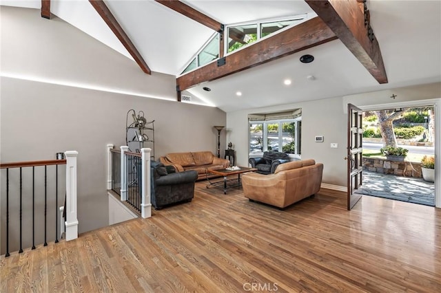 living room with lofted ceiling with beams, recessed lighting, and wood finished floors