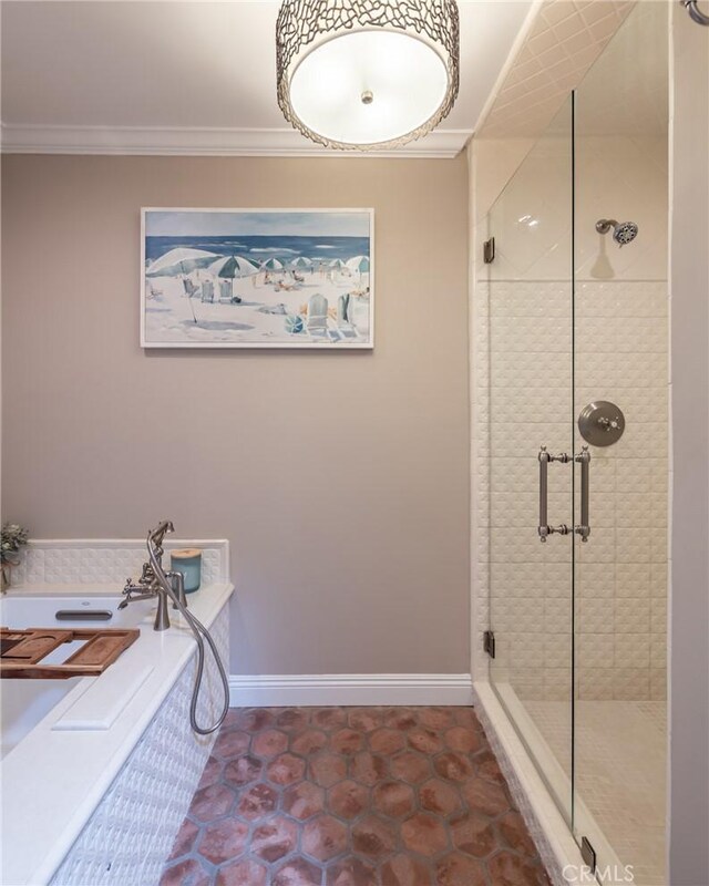 full bath featuring crown molding, baseboards, a bath, and a shower stall