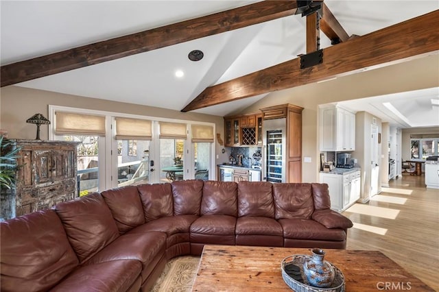 living area featuring recessed lighting, bar area, vaulted ceiling with beams, and light wood-type flooring