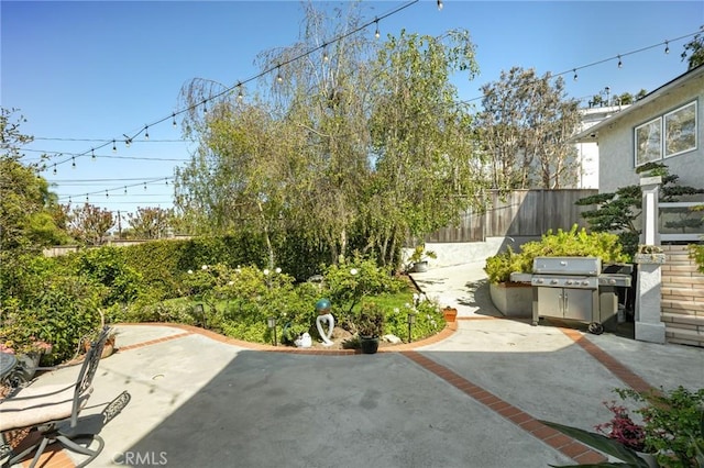 view of yard featuring fence and a patio