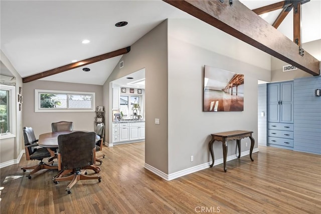 dining space with recessed lighting, baseboards, vaulted ceiling with beams, and light wood finished floors