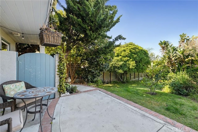view of patio / terrace featuring fence and a gate