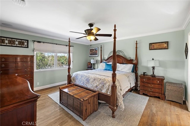bedroom with crown molding, baseboards, ceiling fan, and light wood-type flooring