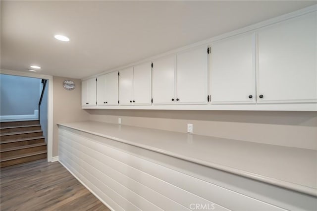 interior space with recessed lighting, baseboards, wood finished floors, and stairway