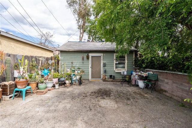 back of property featuring fence and a patio