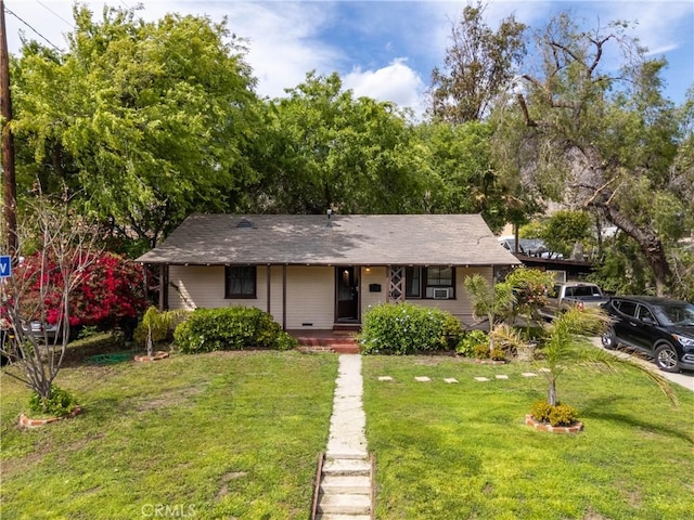 single story home with a porch and a front yard