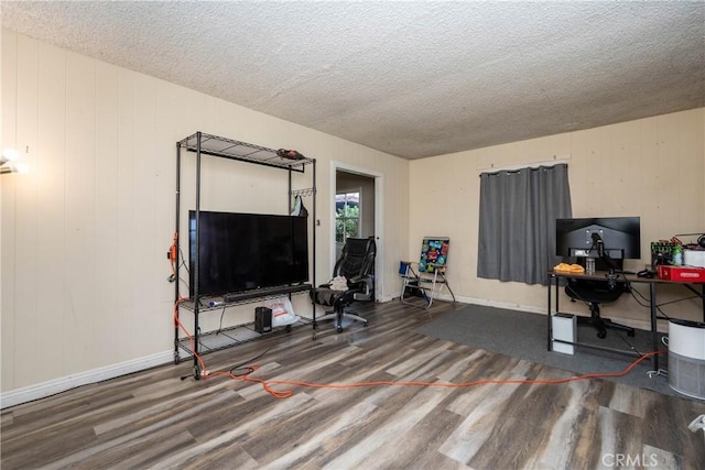home office featuring baseboards, wood finished floors, and a textured ceiling