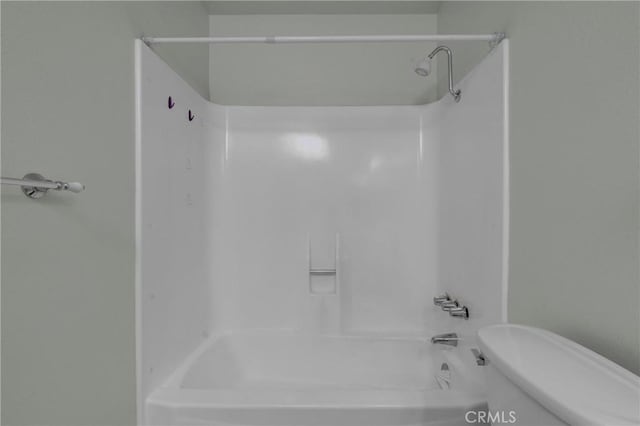 bathroom featuring toilet and  shower combination