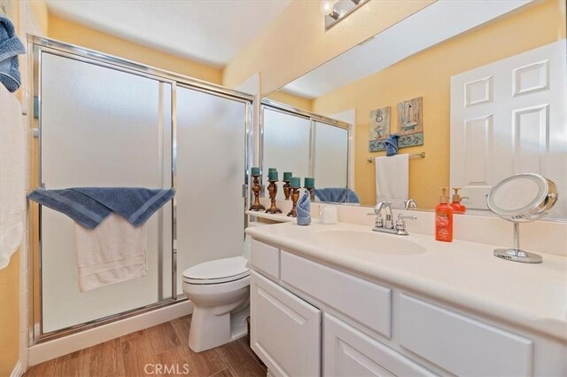 40636 Via Jalapa, Murrieta, CA 92562 - full bathroom with toilet, a shower stall, wood finished floors, and vanity