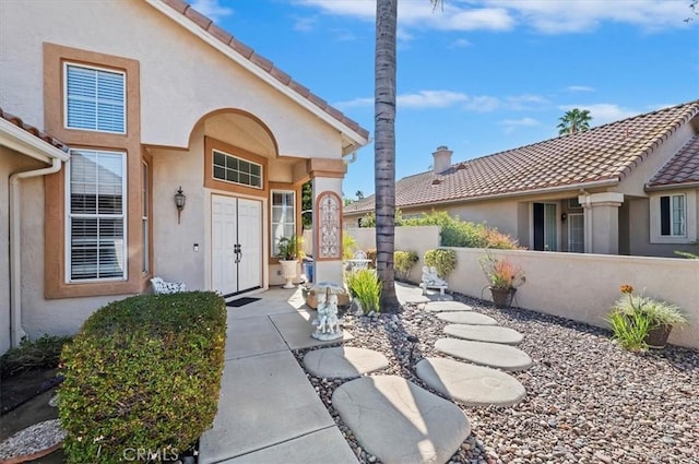 40636 Via Jalapa, Murrieta, CA 92562 - view of exterior entry featuring a tiled roof, fence, and stucco siding