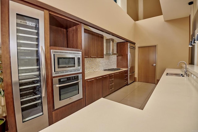 700 W E St Unit 2802, San Diego, CA 92101 - kitchen with built in appliances, wall chimney range hood, a sink, backsplash, and light countertops