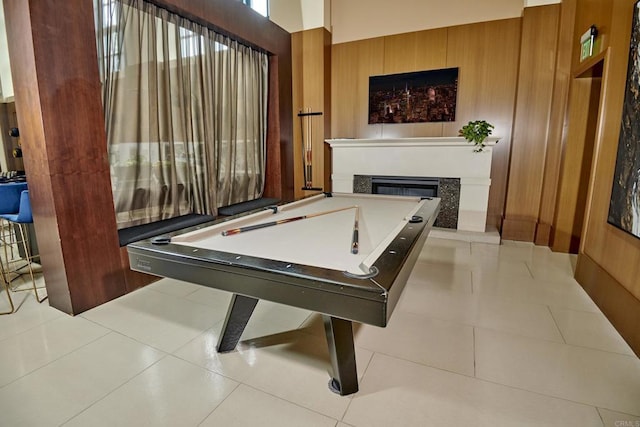 700 W E St Unit 2802, San Diego, CA 92101 - recreation room with wooden walls, a glass covered fireplace, pool table, and tile patterned flooring