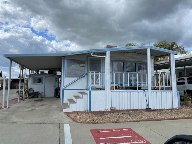view of front of house with an attached carport and covered porch