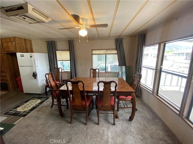carpeted dining room featuring a ceiling fan
