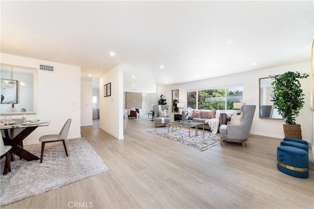9038 Whitaker Ave, Northridge, CA 91343 - living room with light wood-style flooring, recessed lighting, and a chandelier