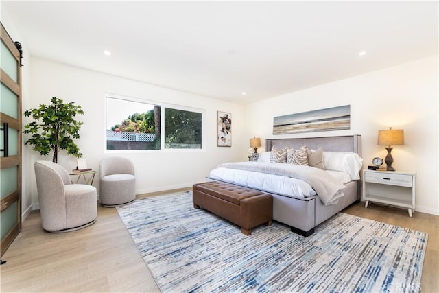 9038 Whitaker Ave, Northridge, CA 91343 - bedroom with wood finished floors, a barn door, and recessed lighting
