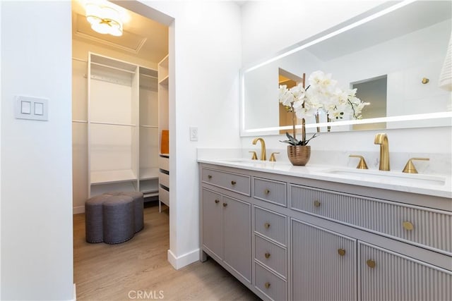 9038 Whitaker Ave, Northridge, CA 91343 - bathroom with wood finished floors, double vanity, and a walk in closet