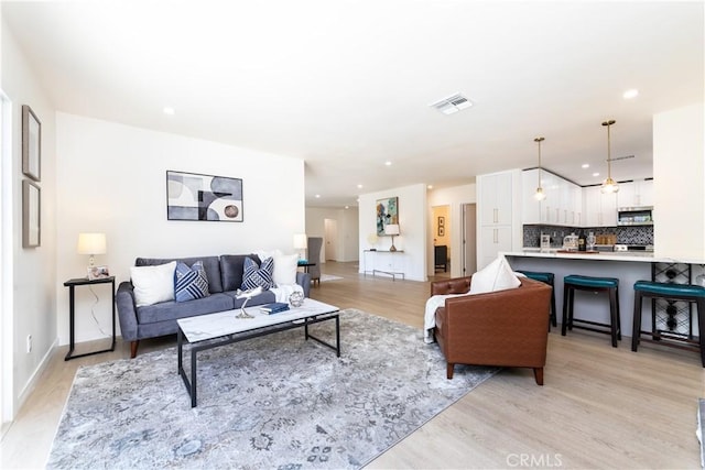 9038 Whitaker Ave, Northridge, CA 91343 - living area with light wood-style flooring and recessed lighting