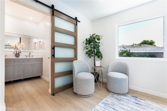 9038 Whitaker Ave, Northridge, CA 91343 - sitting room featuring light wood-style flooring and a barn door