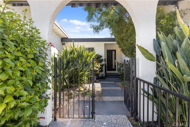 9038 Whitaker Ave, Northridge, CA 91343 - view of exterior entry featuring stucco siding and a gate