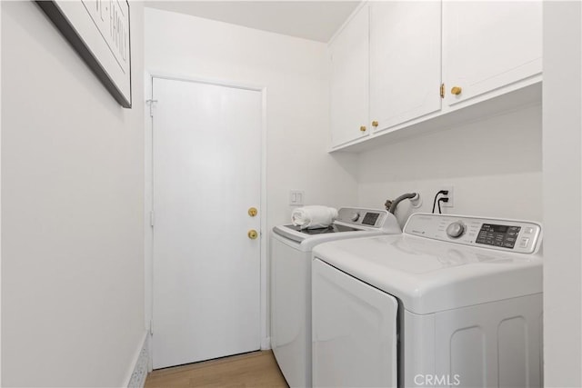 9038 Whitaker Ave, Northridge, CA 91343 - washroom with washer and clothes dryer, cabinet space, and light wood-style floors