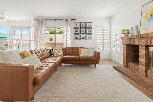 3702 Southridge Way, Oceanside, CA 92056 - living room with light wood-type flooring, baseboards, a brick fireplace, and ceiling fan