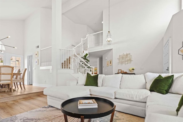 3702 Southridge Way, Oceanside, CA 92056 - living room featuring high vaulted ceiling, stairway, wood finished floors, a chandelier, and baseboards