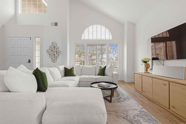 3702 Southridge Way, Oceanside, CA 92056 - living area featuring high vaulted ceiling, light wood finished floors, and baseboards
