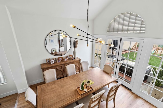 3702 Southridge Way, Oceanside, CA 92056 - dining space featuring a chandelier, french doors, light wood-style flooring, high vaulted ceiling, and baseboards