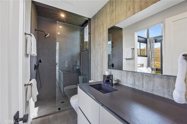 bathroom featuring vanity, toilet, tile patterned flooring, and walk in shower