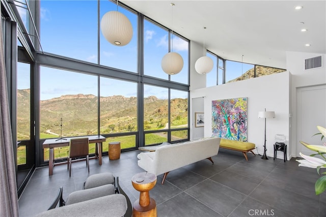 sunroom / solarium featuring a mountain view and visible vents