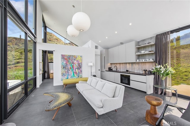 living area featuring visible vents, a wealth of natural light, high vaulted ceiling, and recessed lighting