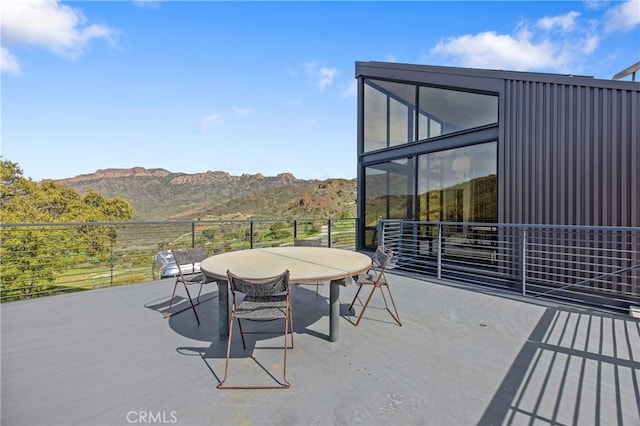 view of patio with a mountain view and outdoor dining space