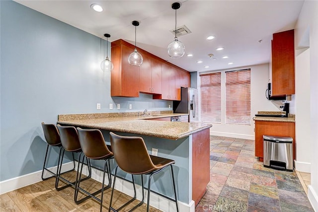 388 E Ocean Blvd Unit 1614, Long Beach, CA 90802 - kitchen with stainless steel appliances, a peninsula, recessed lighting, a kitchen breakfast bar, and decorative light fixtures
