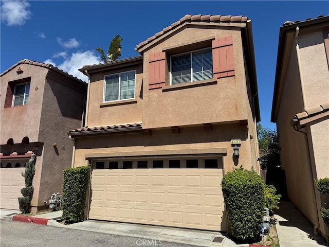 13312 Frederick Way, Sylmar, CA 91342 - view of front facade featuring a tile roof, stucco siding, and an attached garage