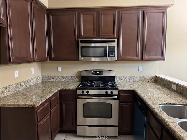 13312 Frederick Way, Sylmar, CA 91342 - kitchen with stainless steel appliances, dark brown cabinetry, and light stone counters