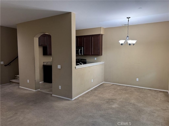 13312 Frederick Way, Sylmar, CA 91342 - kitchen featuring stainless steel microwave, carpet, arched walkways, and dark brown cabinetry