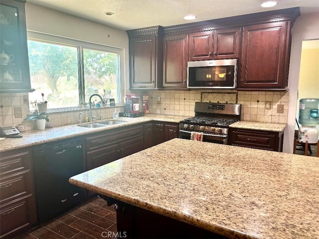 5829 Aurora Ave, Jurupa Valley, CA 91752 - kitchen with stainless steel appliances, a sink, light stone countertops, decorative backsplash, and recessed lighting
