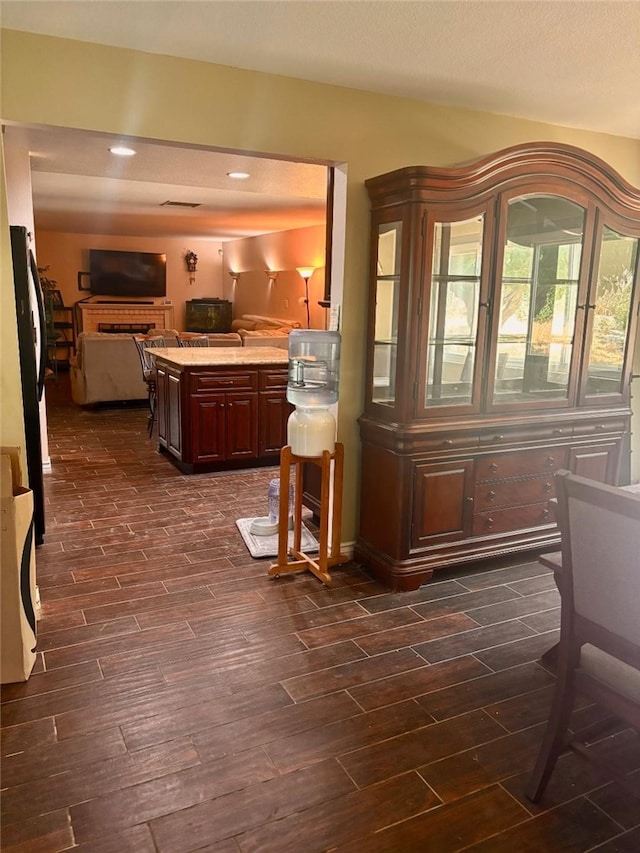 5829 Aurora Ave, Jurupa Valley, CA 91752 - kitchen with freestanding refrigerator, dark wood finished floors, open floor plan, light countertops, and recessed lighting